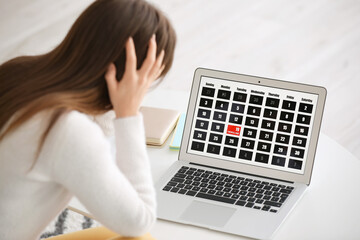 Stressed young woman trying to meet deadline at home