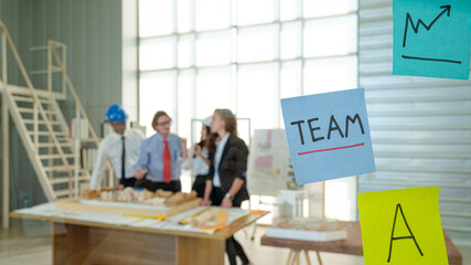 Close up post it note on the glass with business people meeting at the background.