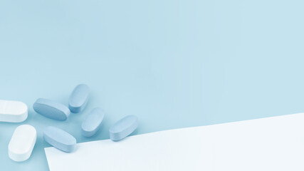 Several white and blue tablets or pills on the table. Medicine and pharmacy