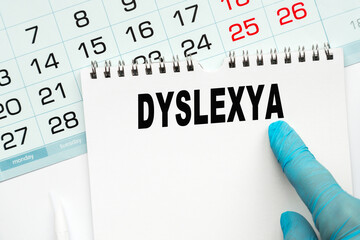 The doctor points to the text DYSLEXYA , medical concept