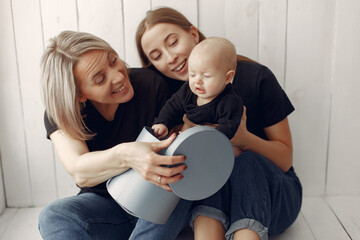 Family at home. Grandmother with daughter and grandson. Women in a black t-shirts.