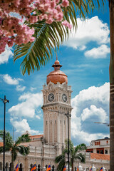 Vertical shot of the Sultan Abdul Samad Building under a blue cloudy sky in Kuala Lumpur, Malaysia