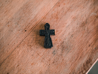 Wooden orthodox cross on wooden table. Handmade wooden cross. symbol of the Christian faith, the main attribute of Christians