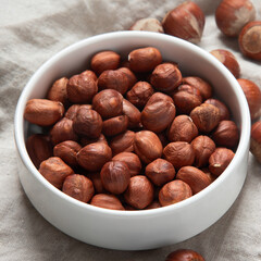 Organic hazelnut in bowl on dark grey