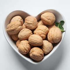 Wallnuts in dark bowl. Healthy vegetarian protein nutritious food. Natural nuts snacks.