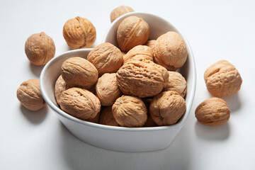 Wallnuts in dark bowl. Healthy vegetarian protein nutritious food. Natural nuts snacks.