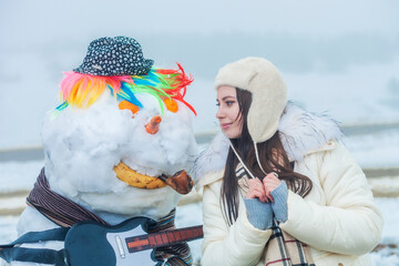 girl with a snowman 
