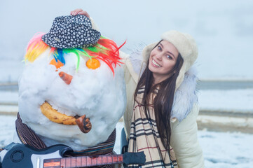 girl with a snowman 

