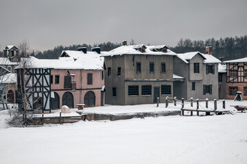 A beautiful village of abandoned houses. Winter snowy day. Cloudy sky.