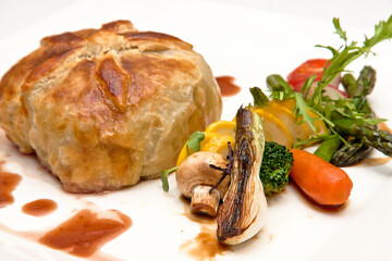 Fillet Wellington in puff pastry with roasted vegetables, Veal Wellington, close up view