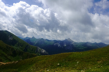 Fototapeta premium hills and mountains with white clouds on the sky