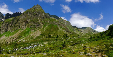 green mountain valley with a brook while hiking panorama