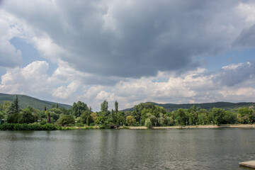 Fototapeta na wymiar Beautiful peaceful nature, trees and plants on a lake, park, summertime season, reflection in the water, Zagorka lake, Stara Zagora, Bulgaria