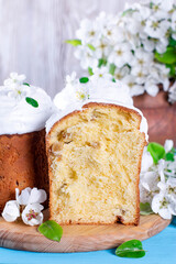Easter composition with traditional Russian Easter bread kulich, Easter eggs and flowers on table. Happy Easter concept