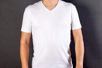 A boy dressed in a white shirt isolated on gray background