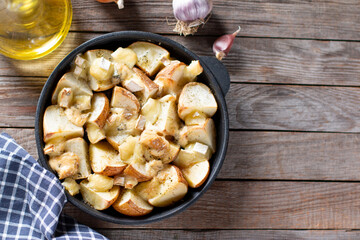 Baked in the oven potatoes with cheese. Top view. Copy space.