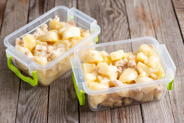 Stewed potatoes with meat in a container. Ready meals. Frozen food.