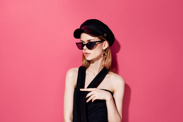 Elegant woman fashion studio luxury black cap pink background