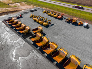 Concept sale of industrial equipment. Parking with big yellow mining truck, bulldozers for coal...