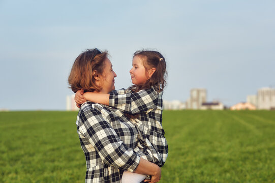 Happy mother and daughter on a country walk .