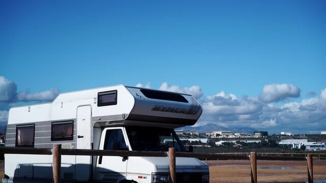Alicante, Spain - December 5, 2019: Old Hymer camper rv on coast near seaside spanish Alacant city on the Costa Blanca. Caravan vacation. Time lapse