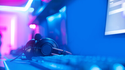 Workplace streamer professional gamer playing online games computer with headphones, neon color © Parilov