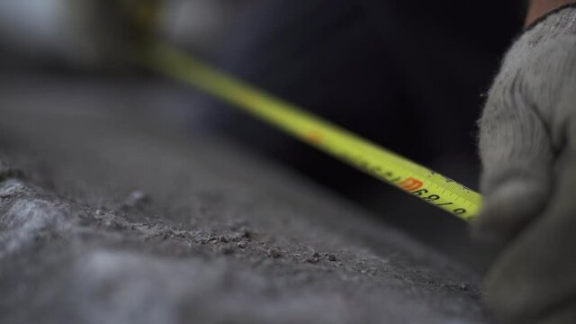 Measuring tape in manufacture of granite slab in production, close up shot