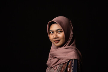 Fashion portrait of young beautiful asian muslim woman with wearing hijab on black background