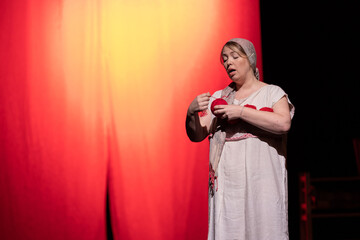 Actress woman plays modern lyrical performance show on the stage of the theater