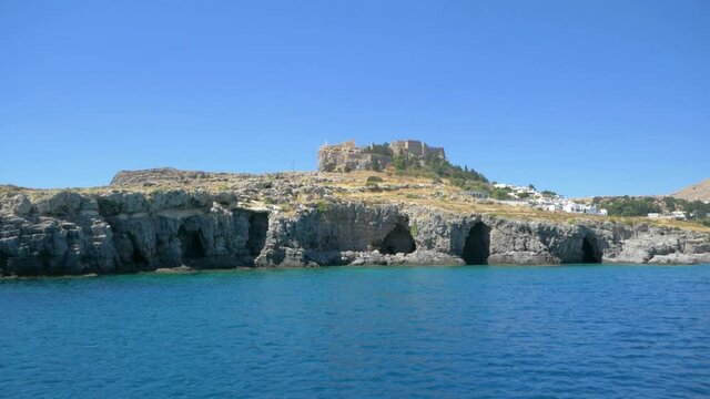 Lovely view of the lake on sunny day with rock castle in the background