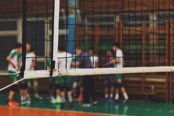 Selective focus: Coach analyze game of volleyball team during timeout in sports gym. Background for...