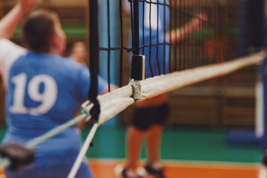 Selective focus: sports Image of volleyball game and net in an old empty sports gym. Background for team volleyball game. Concept of getting sport, healthy lifestyle and team success. Copy space