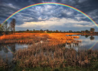 Landscape with a Rainbow on the River in Spring. colorful morning