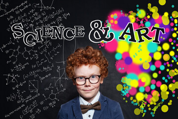 Child boy 9 years old on science and arts pattern background on school chalk board