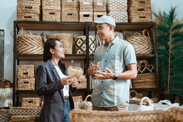 businesswoman and man chat among handicraft items in craft galleries