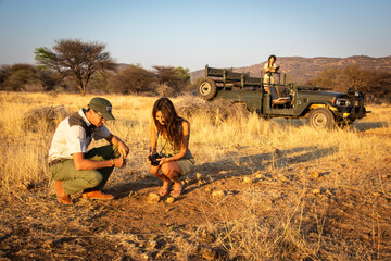 Obraz premium Guide explains something to brunette by jeep