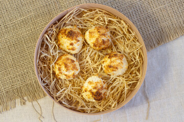 Homemade coconut macaroons coconut meringue cookies, traditional German Christmas cookies Kokosmakronen, wooden basket