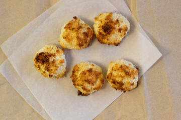 Homemade coconut macaroons coconut meringue cookies, traditional German Christmas cookies Kokosmakronen craft paper