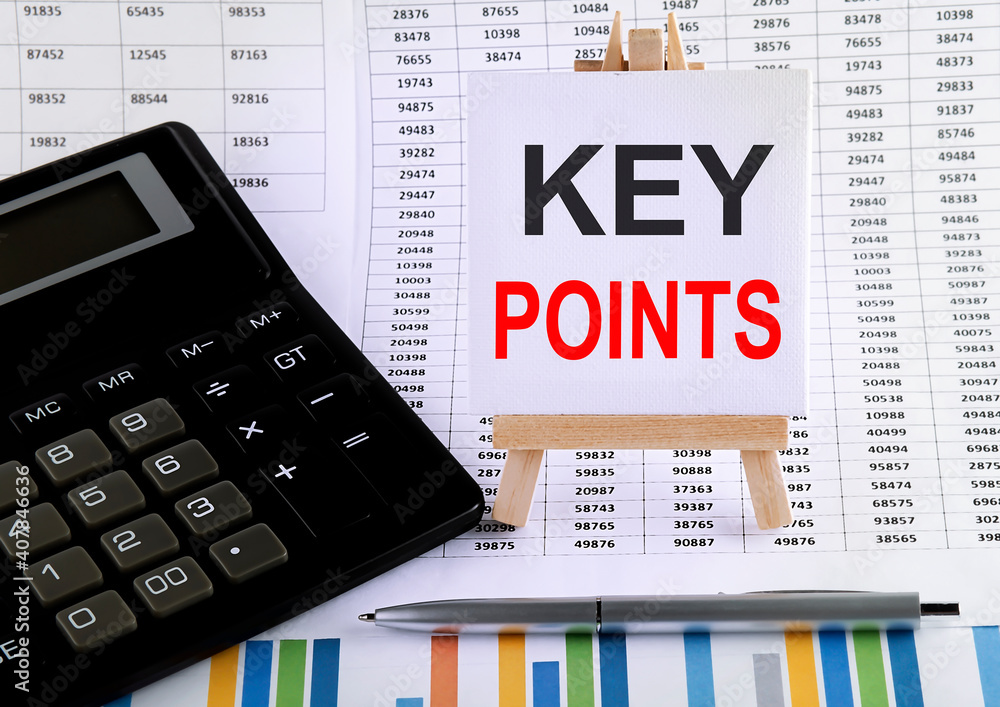 Poster key points on small easel with charts, pen and calculator.business concept.