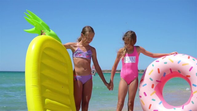 Adorable little girls having fun on the beach
