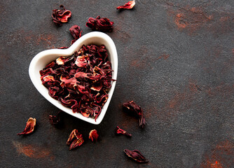 Hibiscus tea in white bowl. Slate background. Copy space.