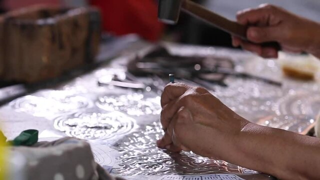 Silverware making. Thai Craftsman are making silverware. The original of the silver craftsmen on Wua Lai road, Chiang Mai. Thailand.