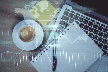 Double exposure of forex chart drawing over table background with computer. Concept of financial...