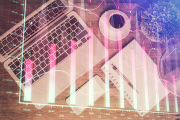 Financial market graph and top view computer on the desktop background. Double exposure. Investment...