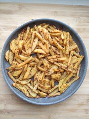 Roasted potato in a frying pan, close up view,