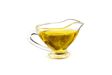 Natural vegetable oil in a small glass cup, isolated on a white background. - obrazy, fototapety, plakaty