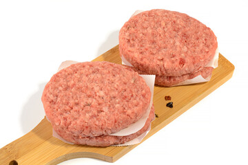 Raw beef patties for making a burger.Isolated on a white background.Selective Focus