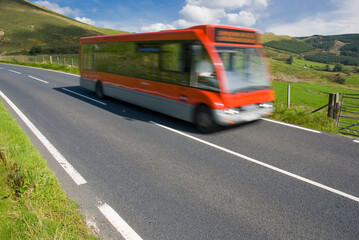 Red bus on rural road