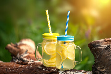 refreshing cold lemonade in a jar on a sunny meadow