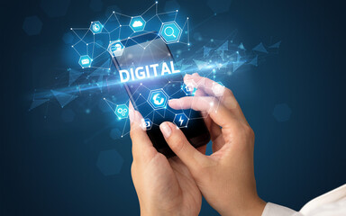 Female hand holding smartphone with DIGITAL inscription, modern technology concept